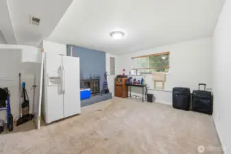 Downstairs recreation room with wood fireplace with large window for lots of natural light!