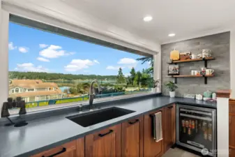 Doing dishes surrounded by honed quartz countertops nad custom designed cabinets while enjoying the view.  Life is good!!