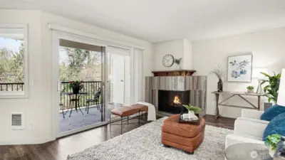 Living room has wood-burning fireplace with upscale tile surround.