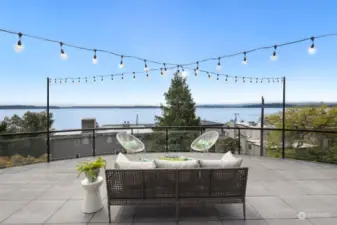 Nestled on a quiet street, this magnificent home offers 180-degree views of Puget Sound and the Olympic Mountains, providing a serene and picturesque backdrop for daily life.