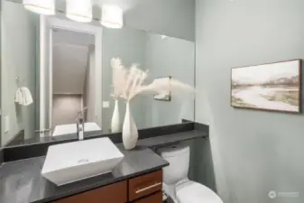 This powder room is conveniently placed in the grand foyer.