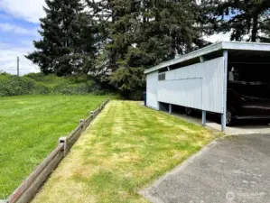 Grass area to the left of the home, maintained by HOA. This makes the home feel secluded and private.