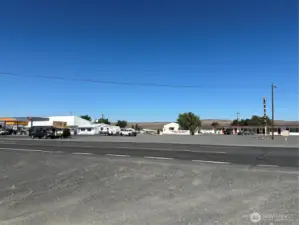 Across intersection from fuel station, motel, and storage units