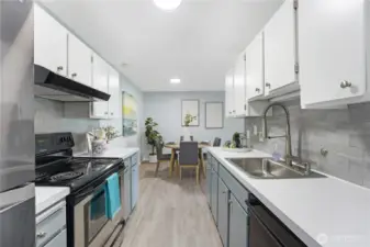 This is the kitchen as you enter the condo on the left.  Newer appliances and lots of storage in this hard working kitchen.  New fixtures throughout the condo and that lovely vinyl flooring.  All new hardware in the kitchen and new backsplash as well