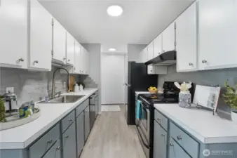 Looking from the dining area into the kitchen.  There is a large closet by the entry (shown straight ahead)