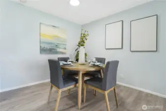 The dining area, here shown with round table and 4 chairs but the space can easily accommodate a rectangular table for six.  The condo was freshly painted throughout