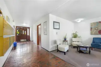 Lobby with mailboxes and sitting area to socialize.  The elevator is straight ahead on the left and the door at the end of the hallway takes you to the swimming pool and cabana