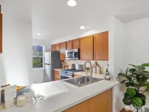 Looking into the morning-light filled kitchen from dining area