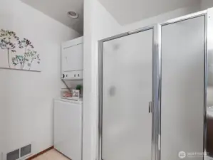 Upstairs 3/4 bathroom shower with stacked washer/dryer