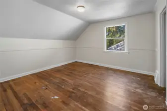Upstairs bedroom with hardwood floors.