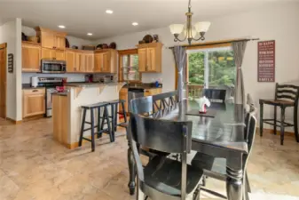 Designed for gathering, the kitchen features an island with an eating bar that opens to the dining room.