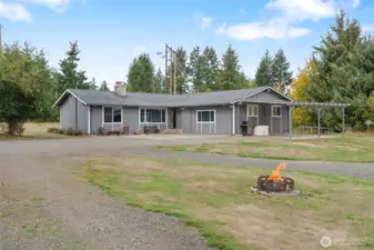 Welcoming front exterior with mature landscaping and country appeal.