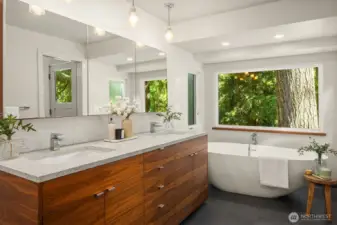 Soaking tub with forest views.