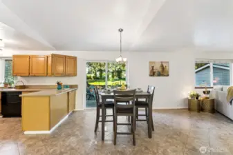 Designer-style, diagonally set tile flooring runs through the traffic areas from the patio door and dining space, through the kitchen and down the entry way to the front door. The large dining area suits many table styles.