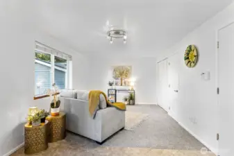 Around the corner from the main living space and adjacent to the dining space, you'll find a generous bonus area ready for many activities.  Set up your media center or hobby area.  Laundry closet and garage entry to the right.