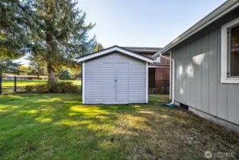 The large garden and lawn tool shed is accessed by the RV parking area and door from the side of the garage.  It also provides a convenient privacy feature between the homes.