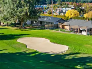 This challenging but pretty sand trap inspires golfers to drive to the opposite side of the fairway away from the home.  Well-groomed golf course lawns frame the pride of ownership seen throughout the neighborhood.