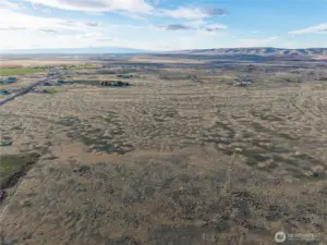 Photo is from the east looking west. The southeast corner is near the squared-off green area on the left. You can draw a straight line through the middle of the photo, northward. Road 10.8 is on the left edge of the photo with no access.