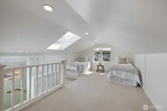 Upstairs you will find a spacious open room staged as a bedroom & office.