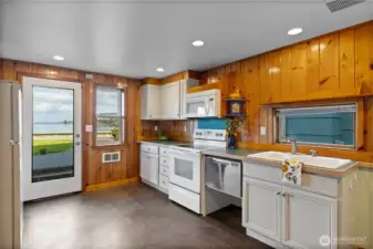Full kitchen continues with the knotty pine wood work.