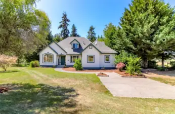 Gorgeous custom home on 5.0 acres with horse arena and 8 stall barn.