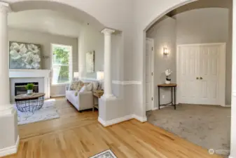 This picture was taken from the entry and faces the formal living room with propane fireplace. The French doors to the right lead to the primary bedroom. Gorgeous oak floors on the main floor.