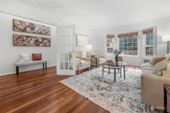 From Dining room, view of foyer through the open glass frenchdoors.  Living room to right with beautiful window overlooking front landscaping.