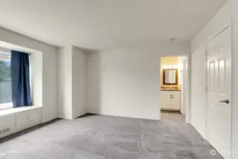 Attached bath with beautiful tile work and walk in closet.