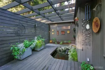 Designer entry courtyard blends indoor-outdoor living with water features & artistic details.