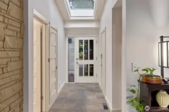 Welcoming entry hallway with slate floors, skylights & modern finishes.