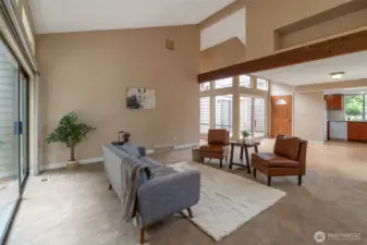 Bright and airy living room with vaulted ceilings, fresh paint, and a cozy fireplace—perfect for relaxing or hosting.