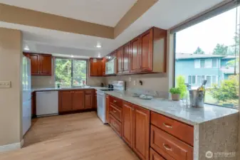 Beautifully updated kitchen featuring hardwood floors, granite countertops, new cabinets, and stainless appliances.