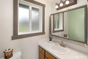 Bathroom with updated shower surround and vanity sink.