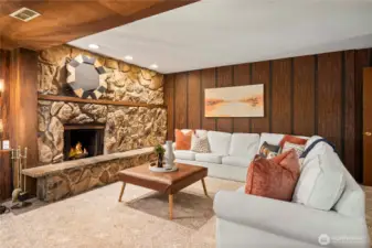 Large accent stone fireplace would look fantastic with some more modern touches throughout this rec room area.