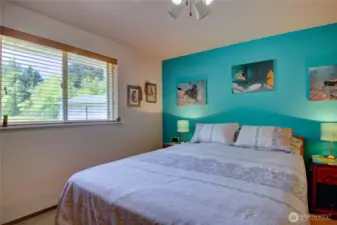 Primary bedroom with large window to bring in the natural light