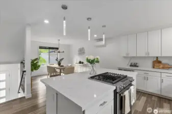 Quartz island and countertops provide ample space and storage, ideal for the discerning chef.