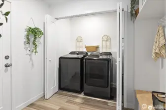 Utility room with newer washer/dryer (both convey) as well as a large folding/hanging/storage space.