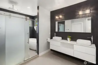 A modern primary bath with a soaking tub and rain shower to end your days.