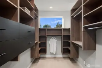 Primary closet with thoughtful shelving and drawers.