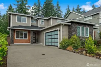 Level driveway leading up to this gorgeous two-car attached garage.