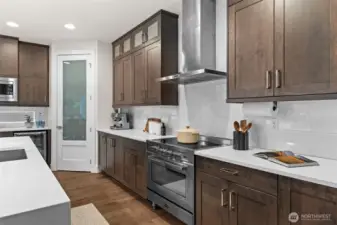 With plenty of cabinetry and a walk-in pantry, this kitchen is built for any of your storage needs.