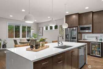 This stunning quartz waterfall kitchen island with sitting space aids in many social gatherings.