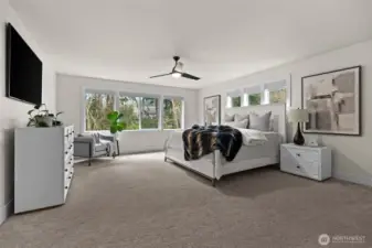 Unwind in this ultra-spacious primary room on the second floor, with wall-to-wall carpeting and flooding with light.
