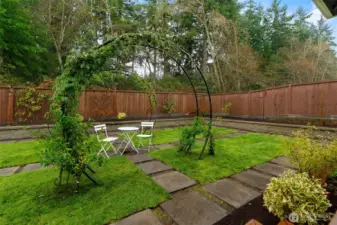 Walk through your backyard on custom stone pavers and a built in garden trellis.