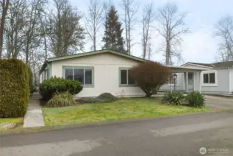 Attractive home with mature landscaping and convenient covered carport in the desirable Mountain View Estates 55+ community.