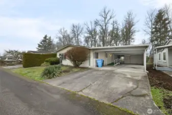 Large covered carport with attached shop and storage area—perfect for projects, hobbies, and extra storage.