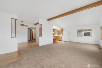 Bright and open living room with vaulted ceilings, large windows, and plenty of space for comfortable seating and entertaining.