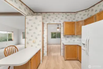 Kitchen breakfast bar with adjoining flexible space ideal for informal dining or sitting area.