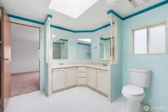Spacious primary bathroom featuring double sinks, ample counter space, and abundant natural light.