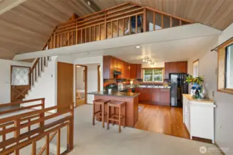 Updated kitchen with leathered slab granite and oak flooring. Main floor bedroom to left of kitchen as well as full bath.